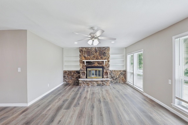 6405 Waynewood Ct, Fort Worth, TX 76135 - unfurnished living room featuring baseboards, ceiling fan, wood finished floors, and a stone fireplace