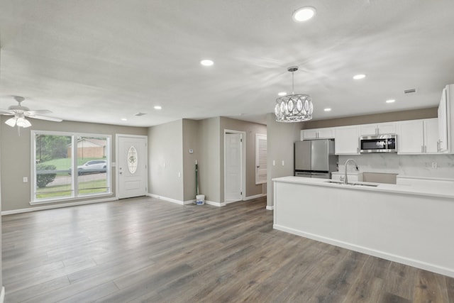 6405 Waynewood Ct, Fort Worth, TX 76135 - kitchen featuring appliances with stainless steel finishes, a sink, baseboards, recessed lighting, and white cabinets