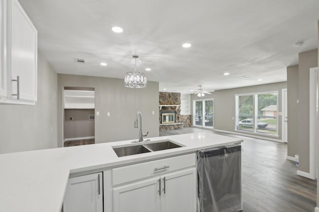 6405 Waynewood Ct, Fort Worth, TX 76135 - kitchen with stainless steel dishwasher, a sink, recessed lighting, white cabinets, and light countertops