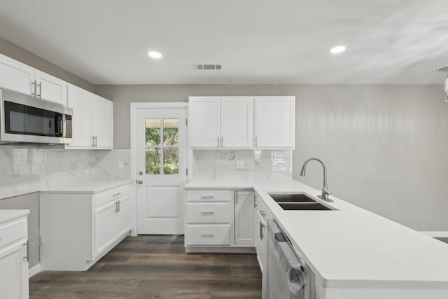 6405 Waynewood Ct, Fort Worth, TX 76135 - kitchen with appliances with stainless steel finishes, a sink, a peninsula, recessed lighting, and tasteful backsplash