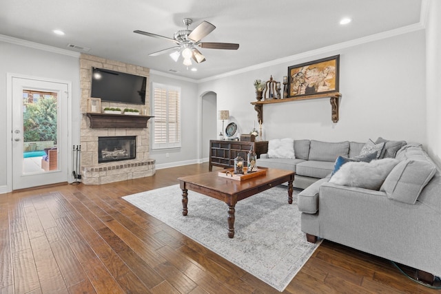 1761 Stillwater Dr, Burleson, TX 76028 - living area featuring plenty of natural light, ceiling fan, arched walkways, dark wood finished floors, and crown molding
