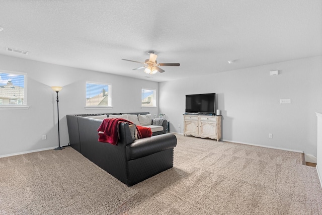 1761 Stillwater Dr, Burleson, TX 76028 - carpeted living area featuring ceiling fan, baseboards, and a textured ceiling