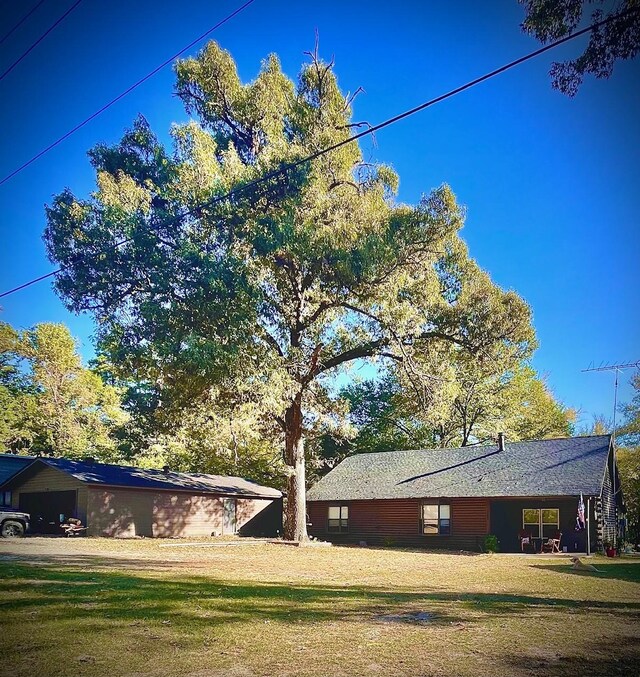 307 S King Lake Rd, Scroggins, TX 75480 - view of home's exterior featuring a lawn