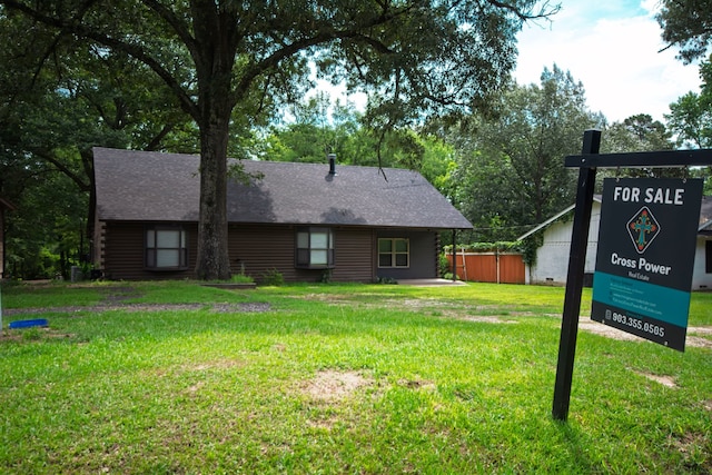 307 S King Lake Rd, Scroggins, TX 75480 - view of front facade featuring a front yard, log siding, and a shingled roof