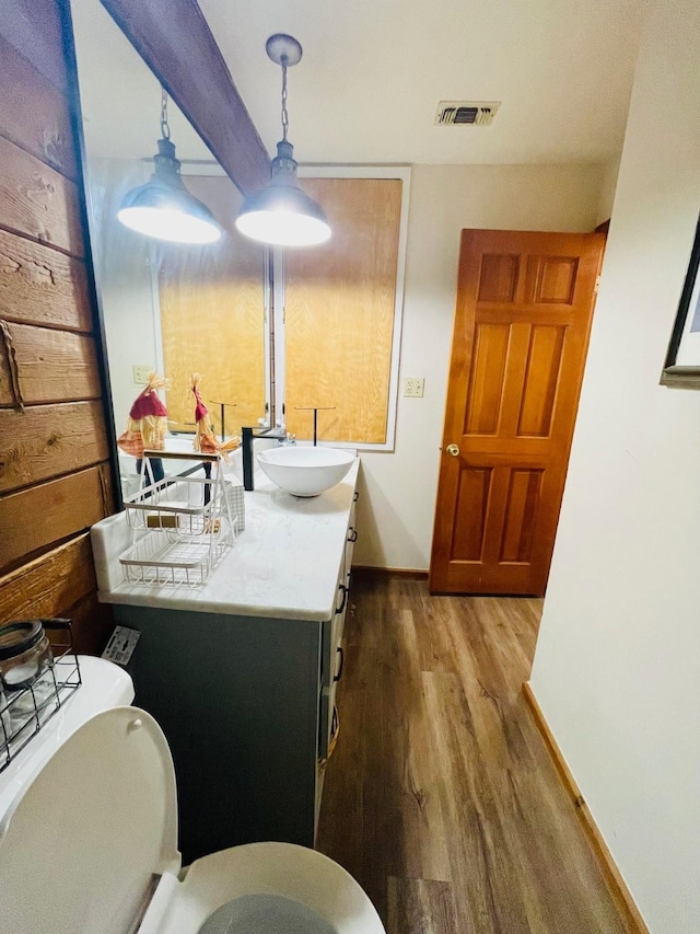 307 S King Lake Rd, Scroggins, TX 75480 - half bathroom featuring baseboards, wood finished floors, toilet, and vanity
