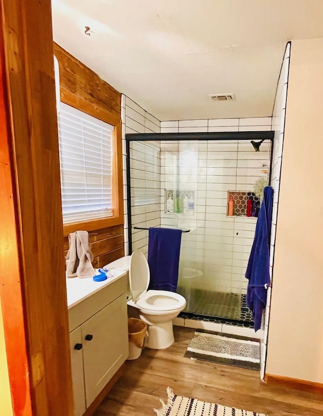 307 S King Lake Rd, Scroggins, TX 75480 - full bathroom featuring wood finished floors, a shower stall, toilet, vanity, and wood walls