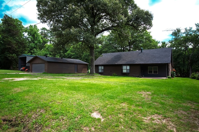 307 S King Lake Rd, Scroggins, TX 75480 - rear view of house featuring a garage, an outdoor structure, and a lawn