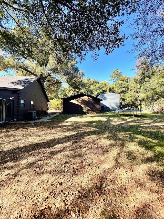 307 S King Lake Rd, Scroggins, TX 75480 - view of yard with a trampoline, an outbuilding, and central AC unit