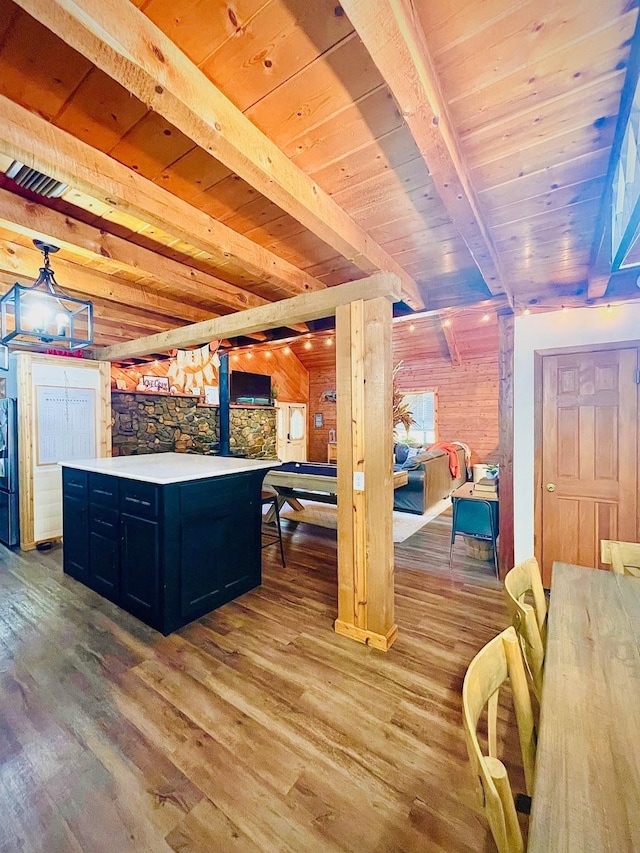 307 S King Lake Rd, Scroggins, TX 75480 - kitchen featuring light wood-type flooring, wooden ceiling with exposed beams, light countertops, dark cabinets, and a kitchen island
