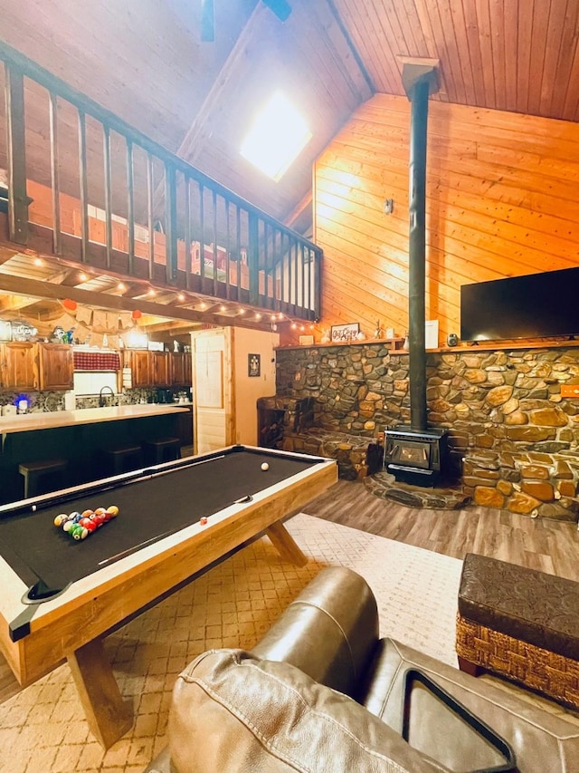 307 S King Lake Rd, Scroggins, TX 75480 - playroom with a wood stove, wood ceiling, wood finished floors, vaulted ceiling, and wood walls