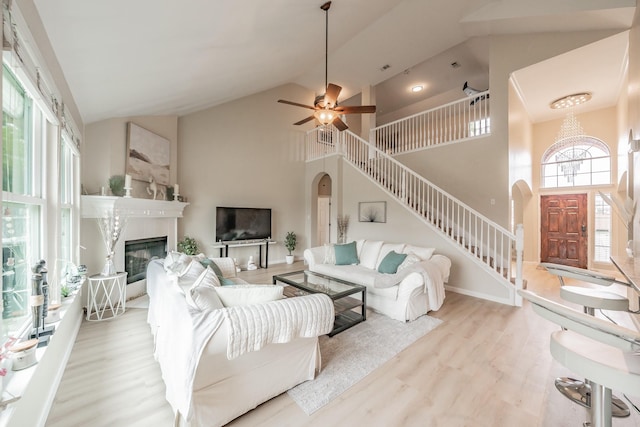 5309 Chatsworth Ln, Fort Worth, TX 76244 - living room with stairs, arched walkways, high vaulted ceiling, wood finished floors, and a glass covered fireplace