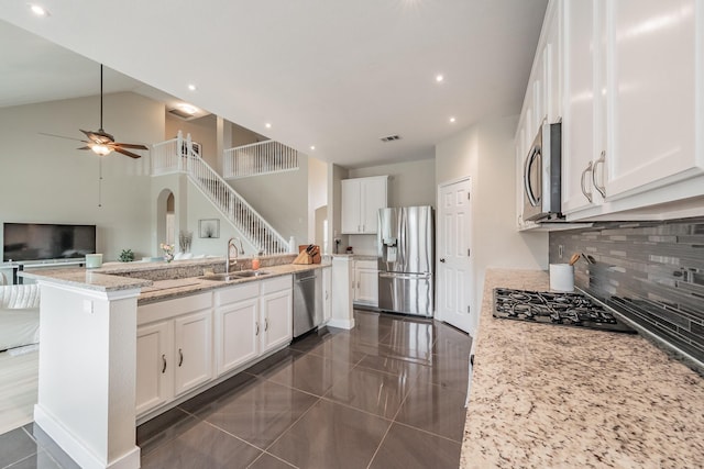 5309 Chatsworth Ln, Fort Worth, TX 76244 - kitchen featuring stainless steel appliances, a sink, white cabinets, a ceiling fan, and light stone countertops