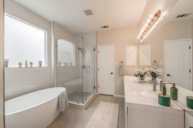 5309 Chatsworth Ln, Fort Worth, TX 76244 - full bathroom with a soaking tub, double vanity, a stall shower, and tile patterned floors