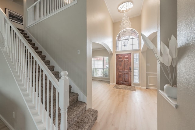 5309 Chatsworth Ln, Fort Worth, TX 76244 - foyer entrance with a towering ceiling, wood finished floors, arched walkways, stairway, and crown molding