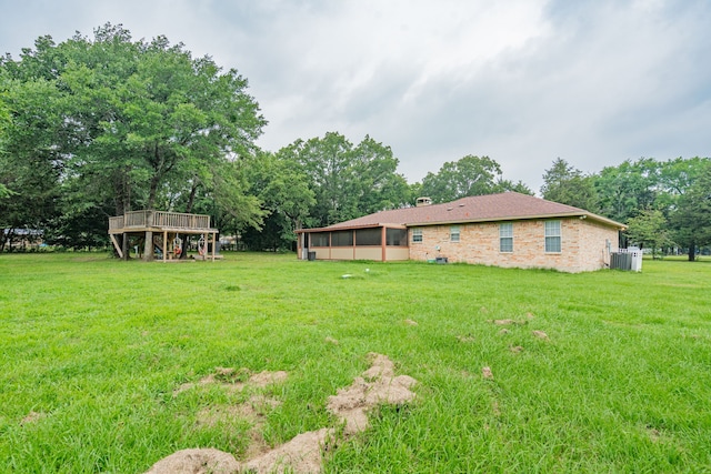 13063 Whiterock Rd, Mabank, TX 75147 - view of grassy yard featuring central AC, view of scattered trees, and a wooden deck