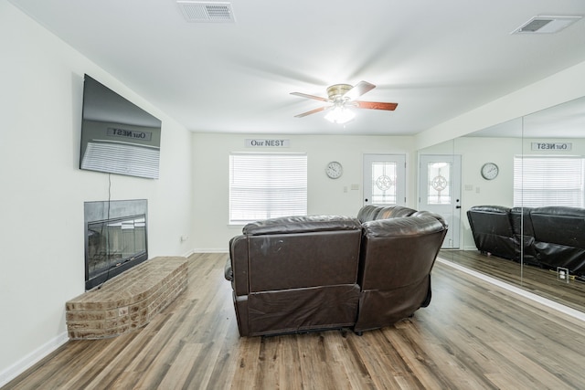 13063 Whiterock Rd, Mabank, TX 75147 - living room with wood finished floors, a fireplace, a ceiling fan, and baseboards