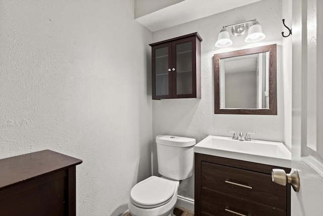 5509 Cloverdale Dr, Fort Worth, TX 76134 - bathroom featuring toilet, vanity, and a textured wall