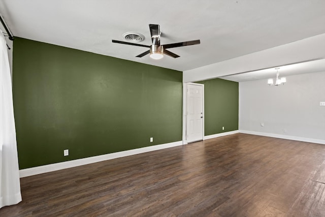 5509 Cloverdale Dr, Fort Worth, TX 76134 - spare room featuring a ceiling fan, dark wood-style floors, a chandelier, and baseboards