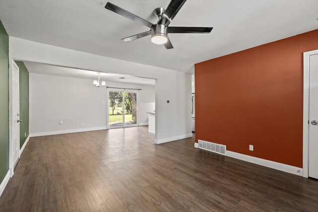 5509 Cloverdale Dr, Fort Worth, TX 76134 - unfurnished living room featuring ceiling fan, a chandelier, dark wood-style floors, and baseboards