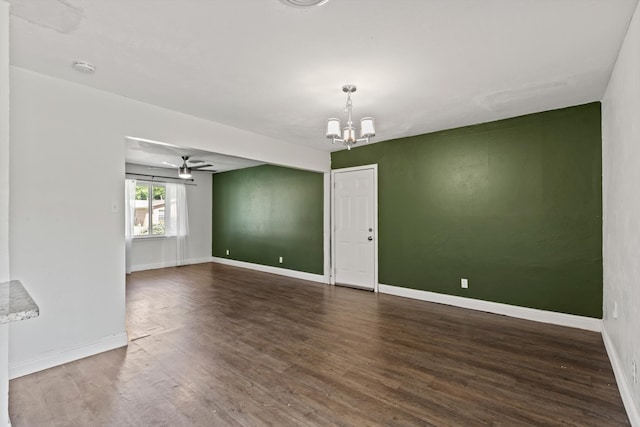 5509 Cloverdale Dr, Fort Worth, TX 76134 - empty room with a chandelier, dark wood-style flooring, baseboards, and ceiling fan