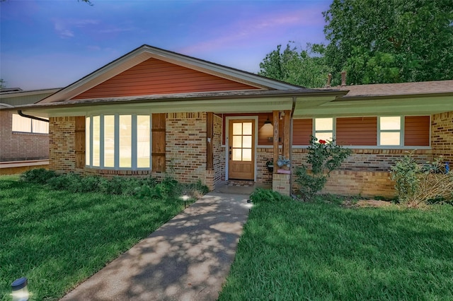 1705 W Belden St, Sherman, TX 75092 - ranch-style house with brick siding, a yard, and covered porch