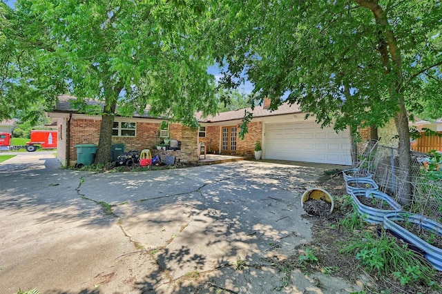 1705 W Belden St, Sherman, TX 75092 - ranch-style house featuring driveway, brick siding, a garage, and french doors