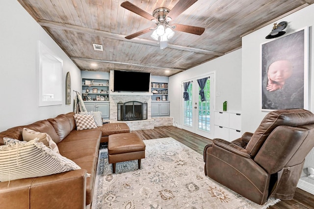 1705 W Belden St, Sherman, TX 75092 - living area featuring wood finished floors, wooden ceiling, ceiling fan, a fireplace with raised hearth, and built in features