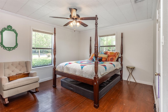 216 E Tennie St, Gainesville, TX 76240 - bedroom featuring baseboards, multiple windows, wood-type flooring, and crown molding