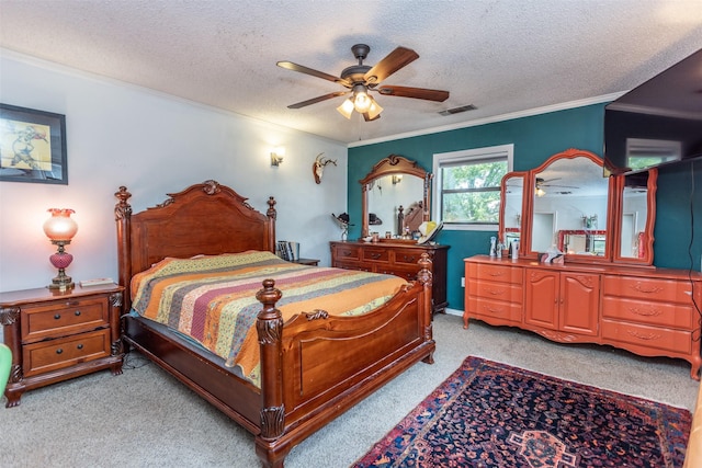 216 E Tennie St, Gainesville, TX 76240 - bedroom with light carpet, crown molding, a textured ceiling, and a ceiling fan
