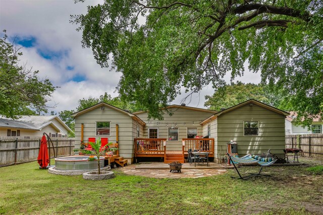 216 E Tennie St, Gainesville, TX 76240 - back of house featuring a wooden deck, a fire pit, and a patio area