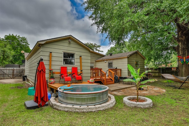216 E Tennie St, Gainesville, TX 76240 - rear view of property featuring a deck and a swimming pool