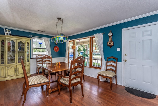 216 E Tennie St, Gainesville, TX 76240 - dining room with a textured ceiling, wood finished floors, ornamental molding, and baseboards