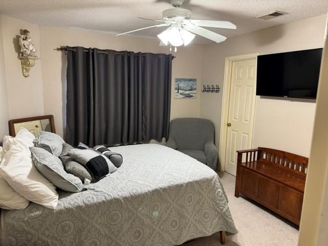 600 Black Rock Ct, Irving, TX 75063 - bedroom with light carpet, ceiling fan, and a textured ceiling