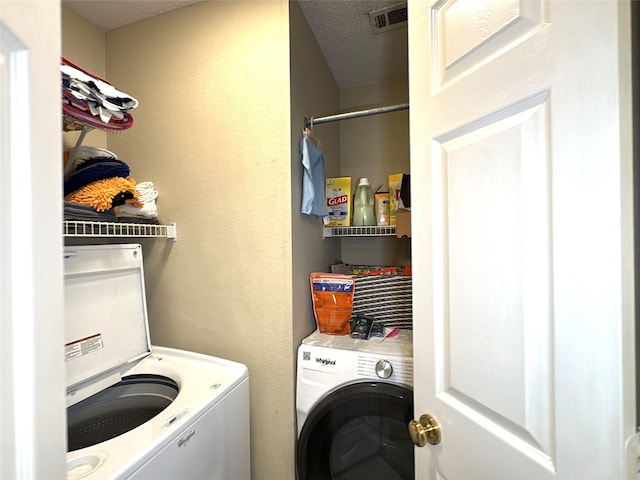 600 Black Rock Ct, Irving, TX 75063 - washroom featuring washing machine and clothes dryer and a textured ceiling
