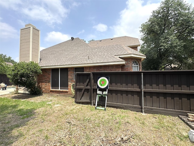 600 Black Rock Ct, Irving, TX 75063 - rear view of house featuring roof with shingles, brick siding, and a chimney