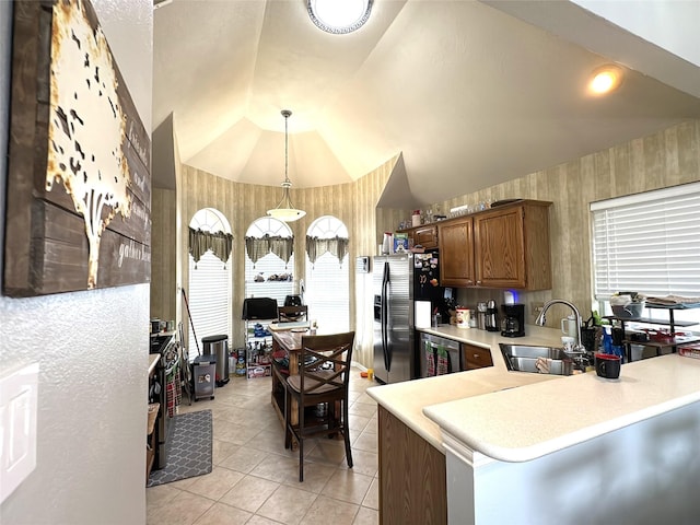 600 Black Rock Ct, Irving, TX 75063 - kitchen featuring a sink, light countertops, light tile patterned floors, stainless steel appliances, and a peninsula