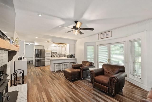 519 S Pearl St, Kemp, TX 75143 - living area featuring a ceiling fan, a fireplace, and dark wood-style floors