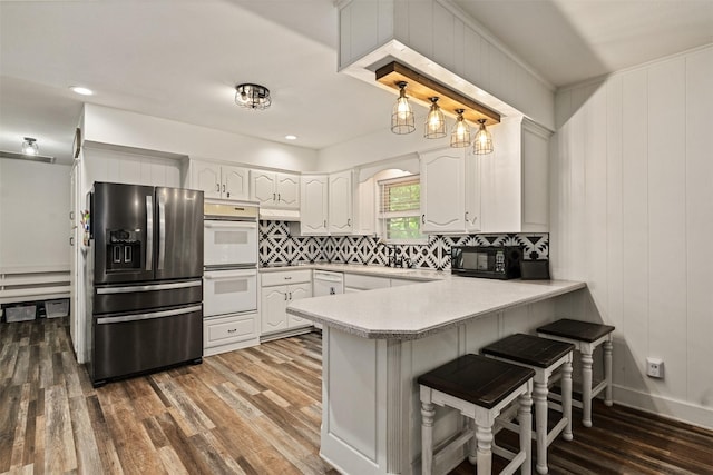 519 S Pearl St, Kemp, TX 75143 - kitchen with refrigerator with ice dispenser, white double oven, a peninsula, white cabinets, and decorative backsplash