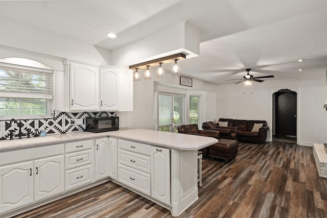 519 S Pearl St, Kemp, TX 75143 - kitchen featuring a peninsula, white cabinets, dark wood-style floors, black microwave, and a sink