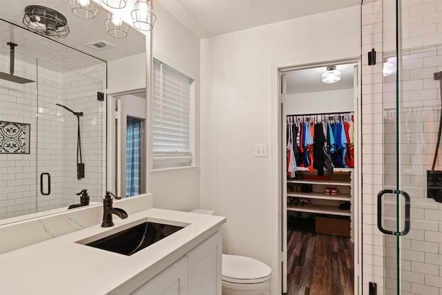 519 S Pearl St, Kemp, TX 75143 - bathroom featuring vanity, a walk in closet, wood finished floors, and a stall shower