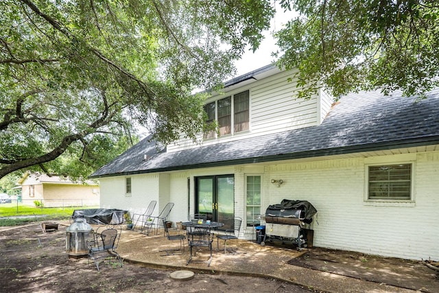 519 S Pearl St, Kemp, TX 75143 - back of property with brick siding, a patio area, and a shingled roof