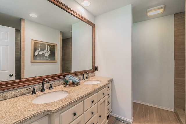 1233 Stegall Rd, Keller, TX 76248 - bathroom with double vanity, wood finished floors, recessed lighting, and baseboards
