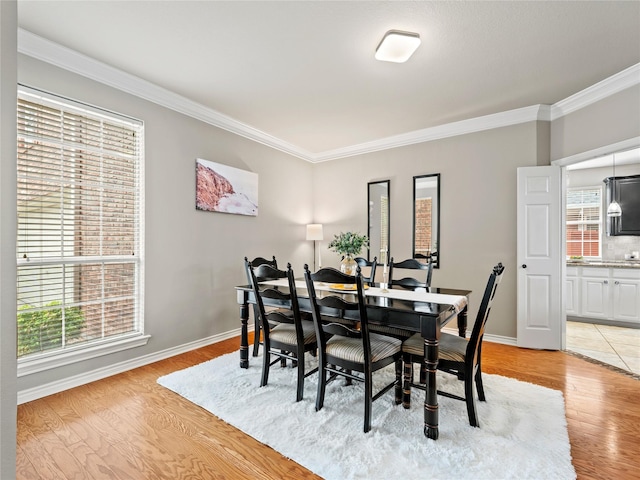 1308 Crown Point Rd, Mckinney, TX 75072 - dining area featuring ornamental molding, light wood-type flooring, and baseboards