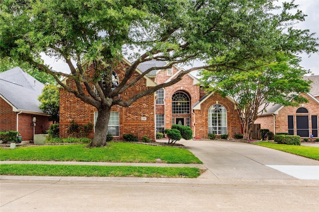 1308 Crown Point Rd, Mckinney, TX 75072 - traditional-style house featuring brick siding and a front yard