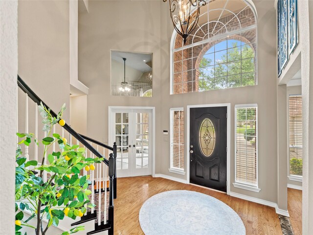 1308 Crown Point Rd, Mckinney, TX 75072 - foyer entrance with a towering ceiling, french doors, wood finished floors, a chandelier, and baseboards