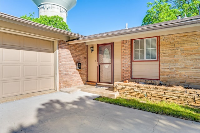 403 E Alexander Ln, Euless, TX 76040 - view of exterior entry featuring brick siding, driveway, and a garage