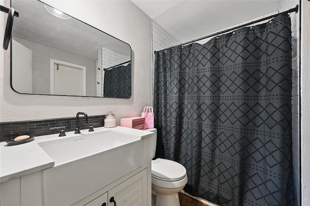 1420 Glacier Dr, Plano, TX 75023 - bathroom with toilet, vanity, a textured wall, decorative backsplash, and a shower with shower curtain