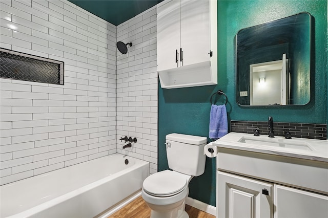 1420 Glacier Dr, Plano, TX 75023 - bathroom with toilet, wood finished floors, shower / washtub combination, vanity, and decorative backsplash