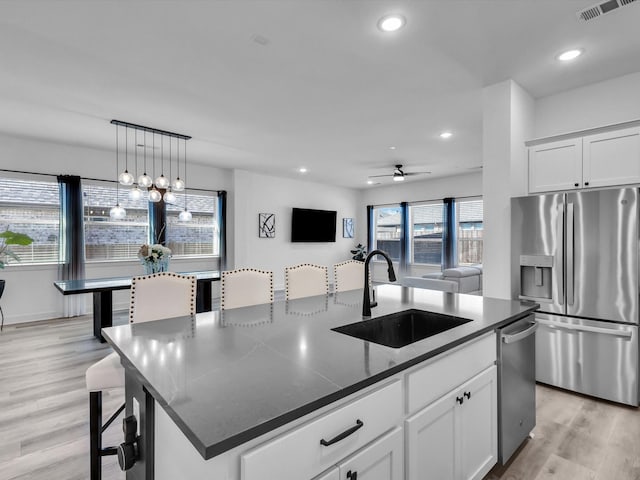 1708 Jamestown Dr, Forney, TX 75126 - kitchen featuring appliances with stainless steel finishes, a sink, an island with sink, light wood-type flooring, and recessed lighting