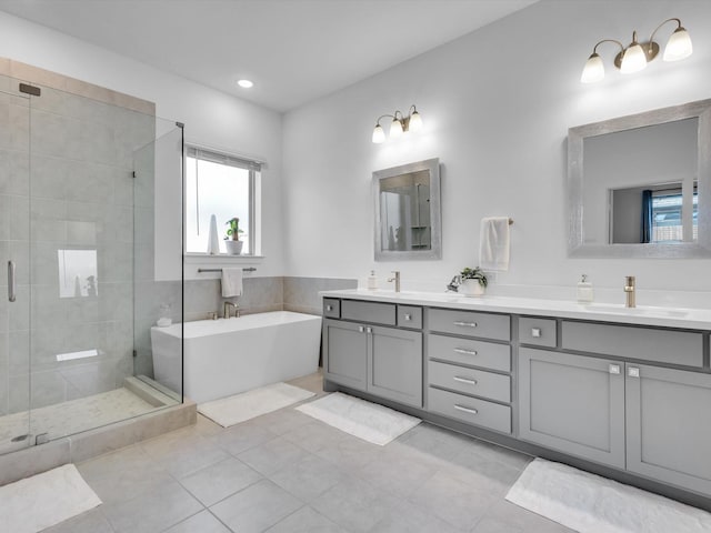1708 Jamestown Dr, Forney, TX 75126 - bathroom featuring a shower stall, tile patterned flooring, double vanity, a freestanding tub, and recessed lighting